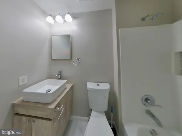 a bathroom with a sink a toilet and mirror