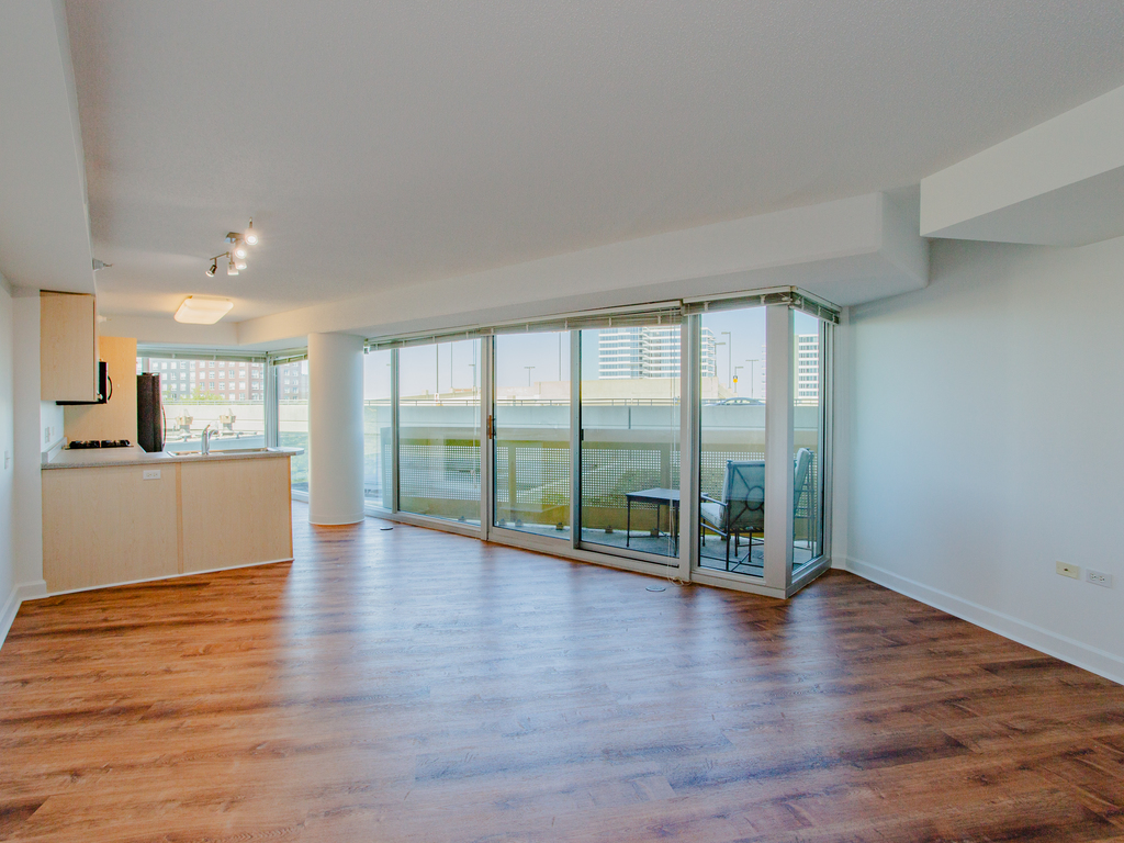 1720 Maple Avenue, Unit 660 Evanston, IL 60201 - Photo 7 of 16 a view of an empty room with wooden floor and a window