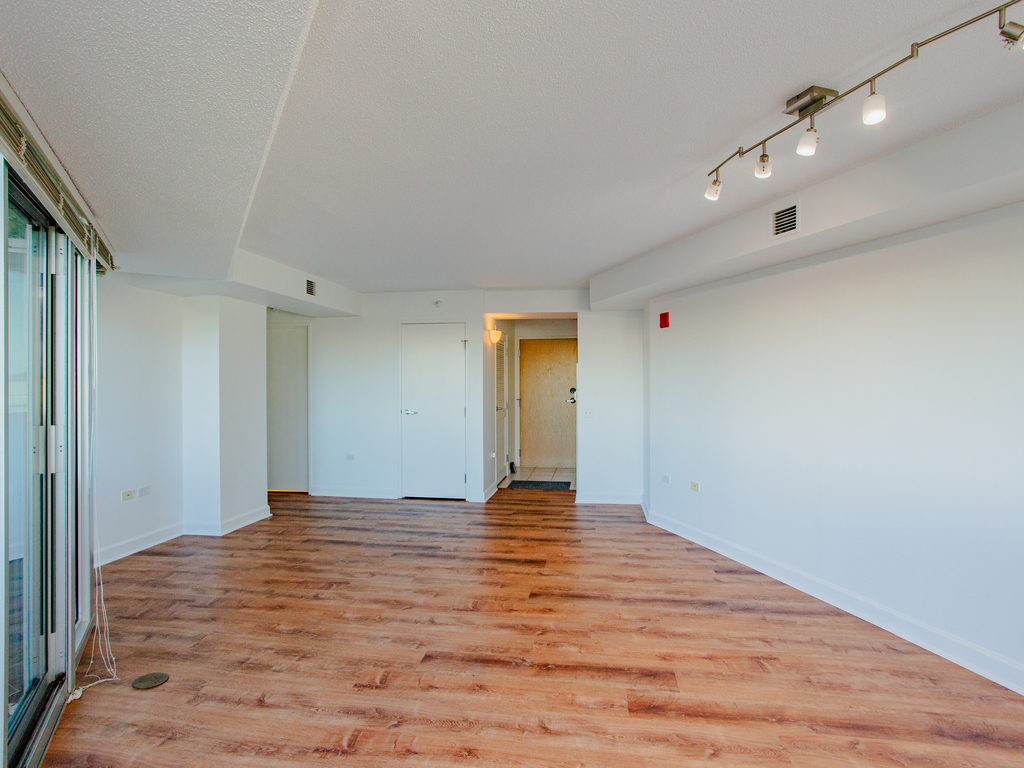 1720 Maple Avenue, Unit 660 Evanston, IL 60201 - Photo 8 of 16 a view of an empty room with wooden floor and a window