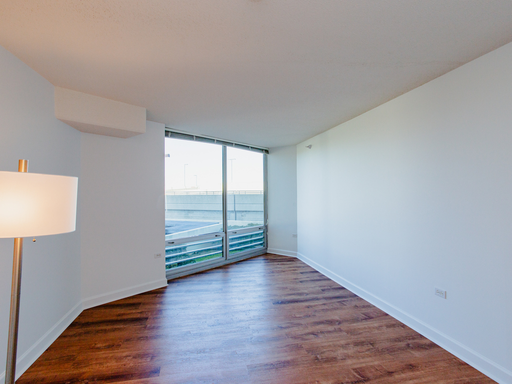 1720 Maple Avenue, Unit 660 Evanston, IL 60201 - Photo 9 of 16 wooden floor in an empty room with a window