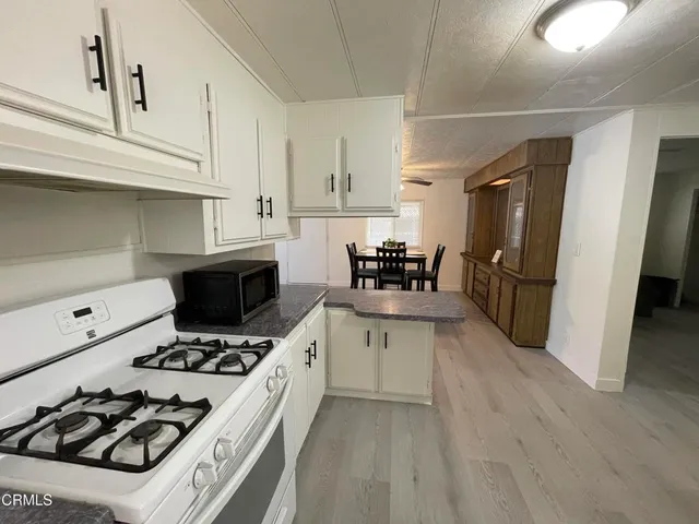 a kitchen with a stove a refrigerator and a sink