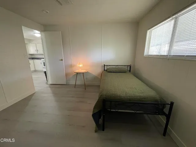 a room with pool table and windows