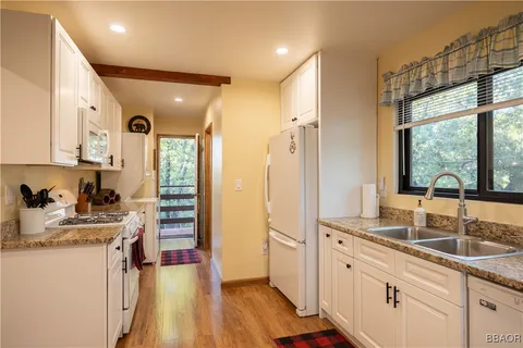 a kitchen with sink refrigerator and window