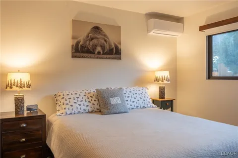 a bedroom with a bed and painting on the wall