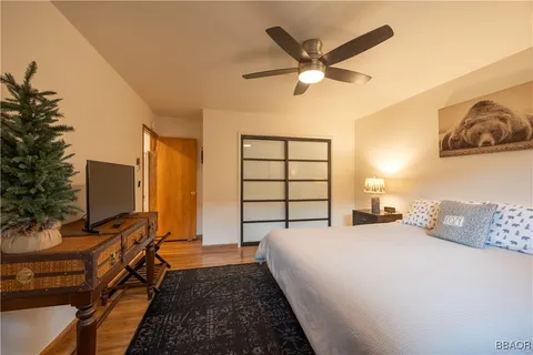 a bedroom with a bed and a flat screen tv