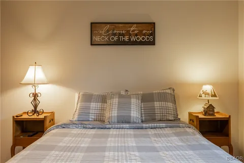 a view of a room with wooden floor and a potted plant