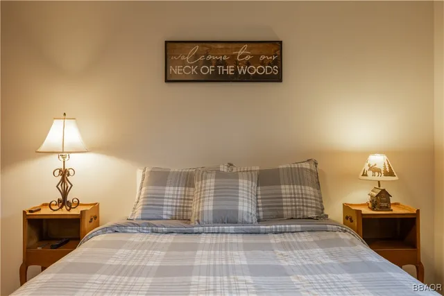 a view of a room with wooden floor and a potted plant