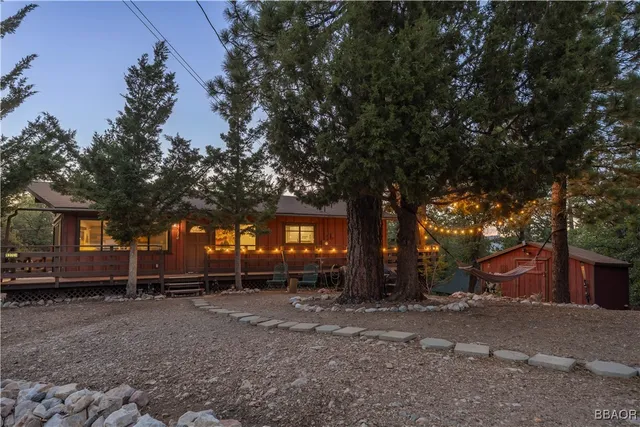 a view of a house with a tree in front of it