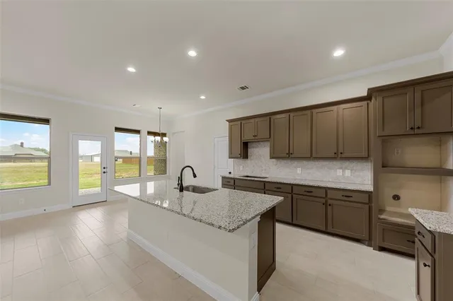 a kitchen with a sink and a stove top oven