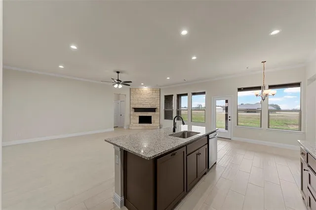 a hall with kitchen island a large window appliances and furniture