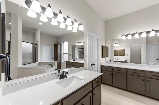 a bathroom with a sink double vanity and a mirror