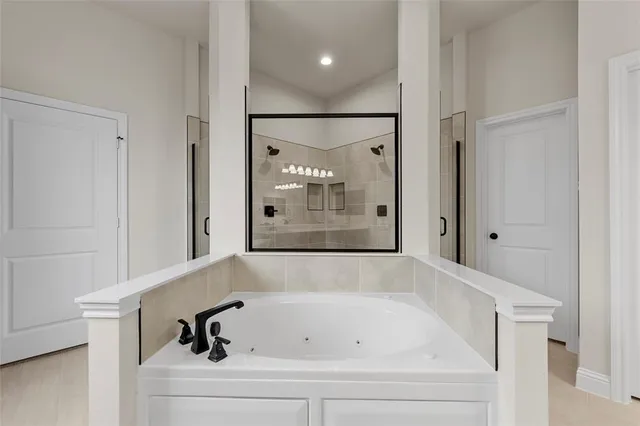 a bathroom with a bathtub and shower
