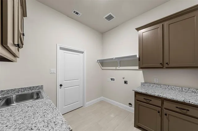 a kitchen with granite countertop a sink and cabinets