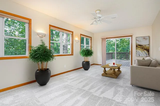 a living room with furniture tv and window