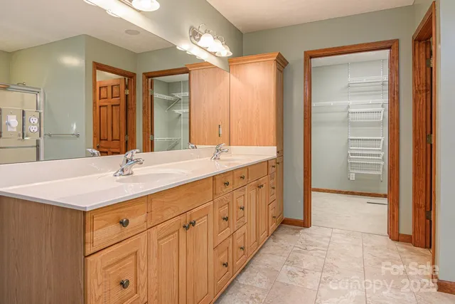 a bathroom with a double vanity sink and a mirror