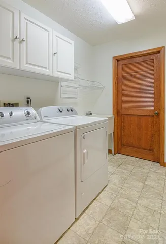 a utility room with sink dryer and washer