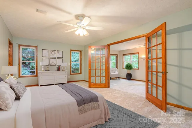 a spacious bedroom with a bed and a large window