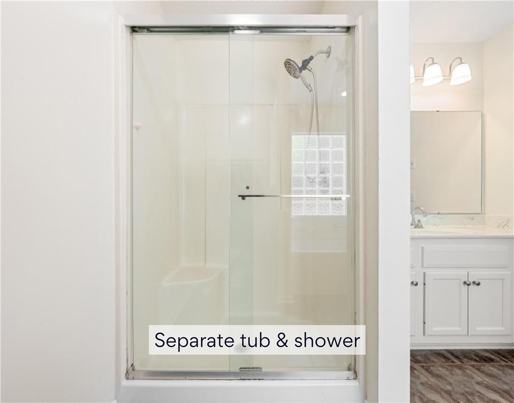 848 Perkins Creek Road Seneca, SC 29678 - Photo 15 of 26 A well-appointed bath features a shower with sliding glass doors, complementing the adjacent vanity.