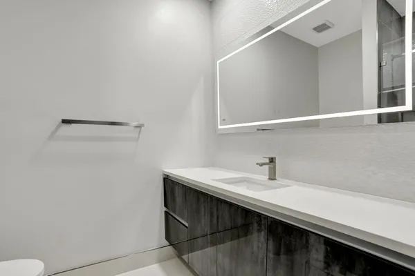 a bathroom with a sink and a mirror