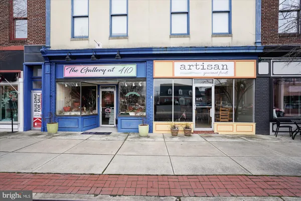 a view of a patio with table and chairs and floor to ceiling window