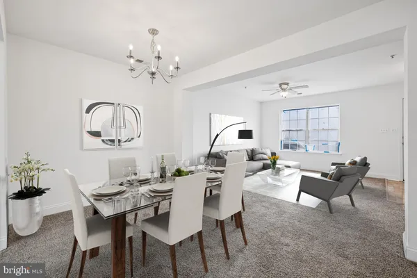 a view of a dining room with furniture a chandelier and wooden floor