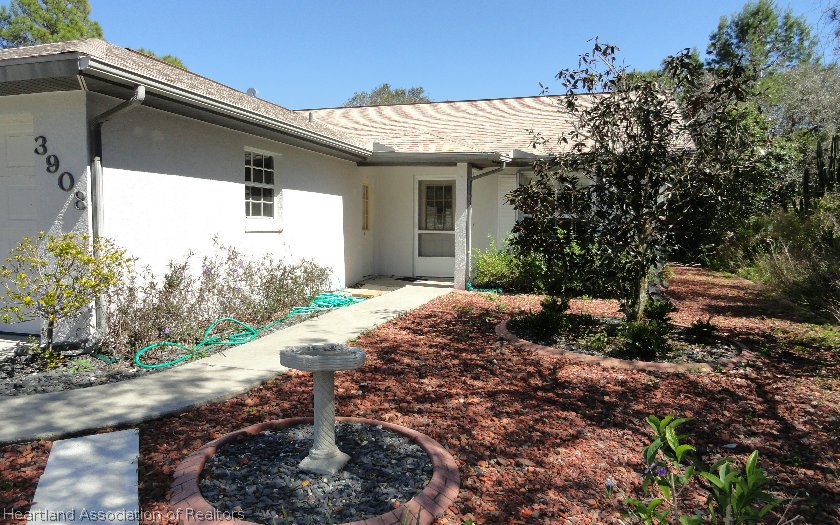 3908 Mandarin Road Sebring, FL 33875 - Photo 1 of 1 a front view of a house with garden