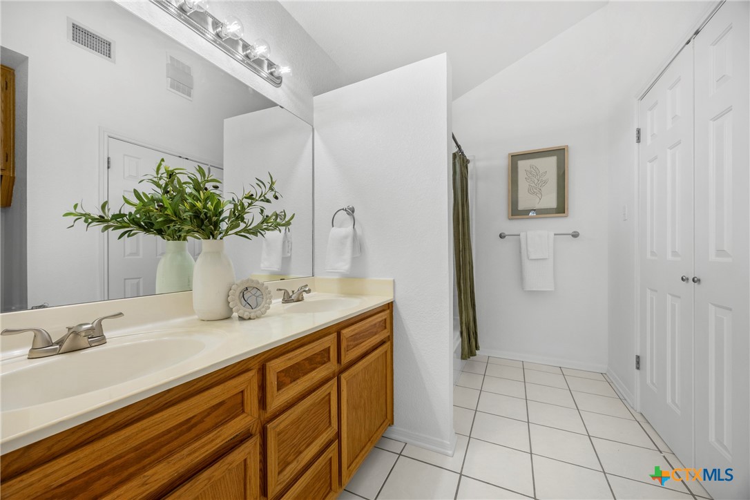 5107 Denmans Loop Belton, TX 76513 - Photo 24 of 48 a bathroom with a granite countertop sink a mirror and a shower