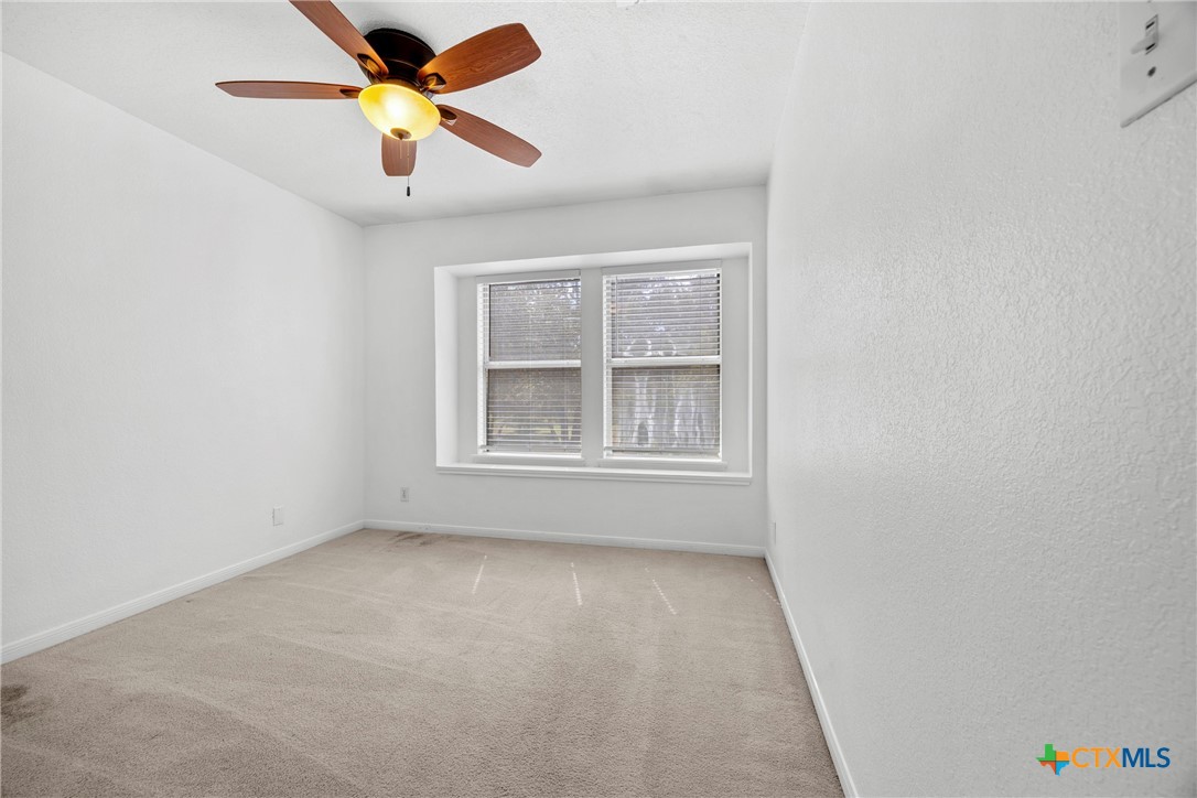 5107 Denmans Loop Belton, TX 76513 - Photo 27 of 48 a view of an empty room with window and a chandelier fan