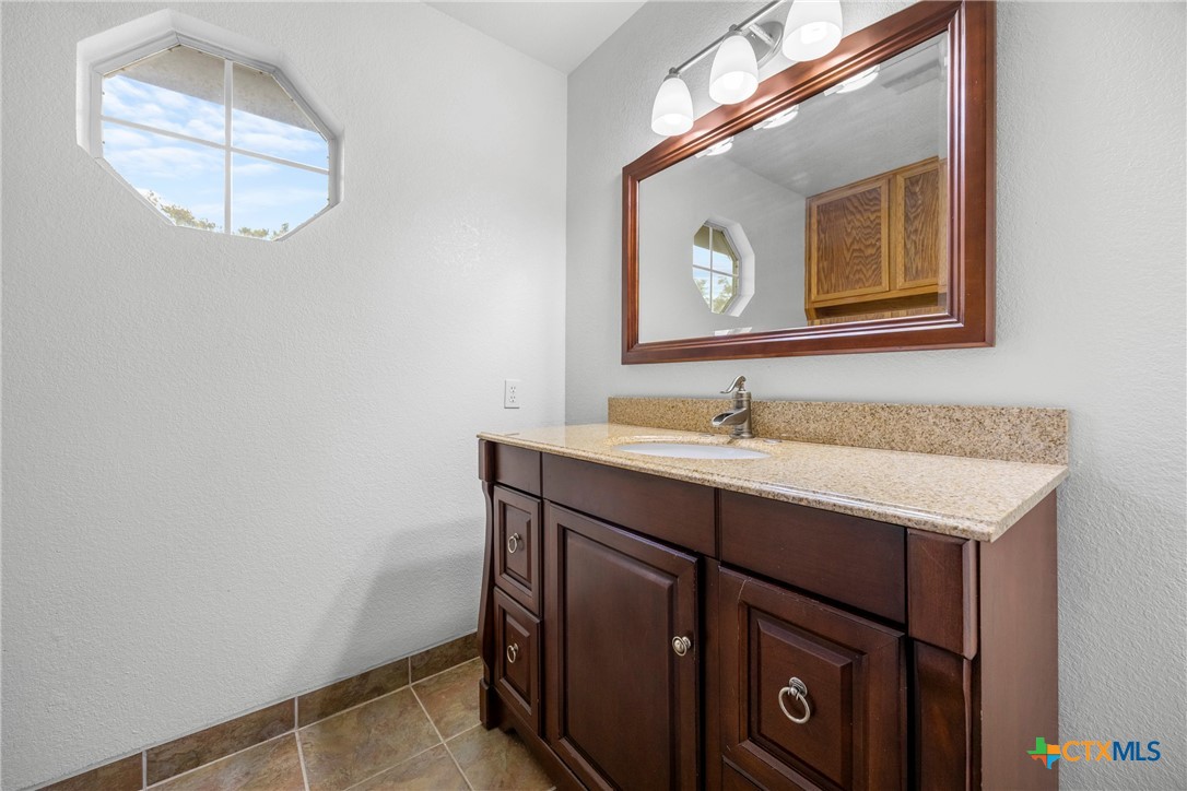 5107 Denmans Loop Belton, TX 76513 - Photo 29 of 48 a bathroom with a sink vanity and a mirror