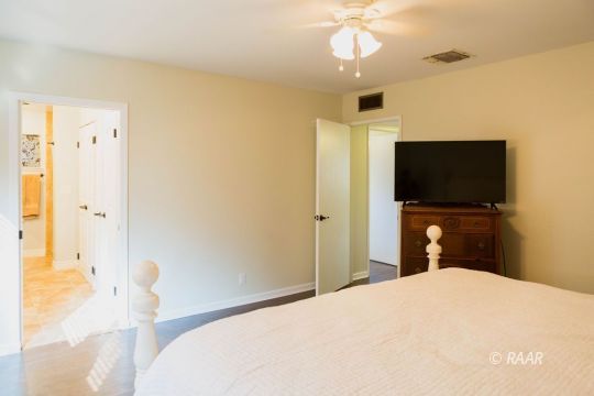 730 Scott Circle Ridgecrest, CA 93555 - Photo 18 of 32 a bedroom with a bed and a flat tv screen on dresser