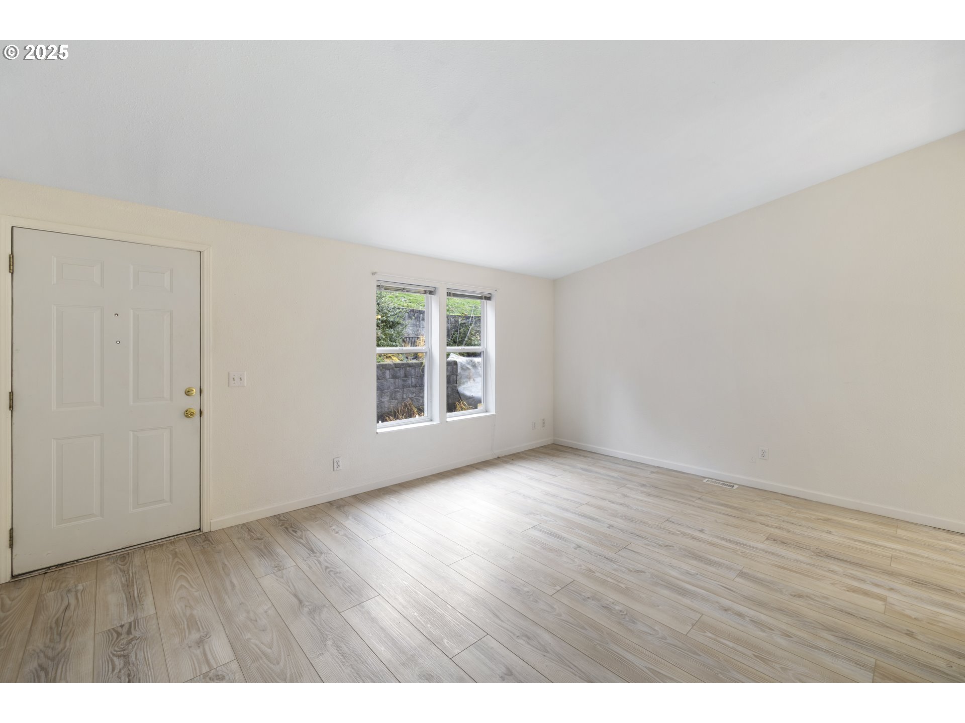 1115 China Garden Road Kalama, WA 98625 - Photo 11 of 40 a view of an empty room with wooden floor and a window