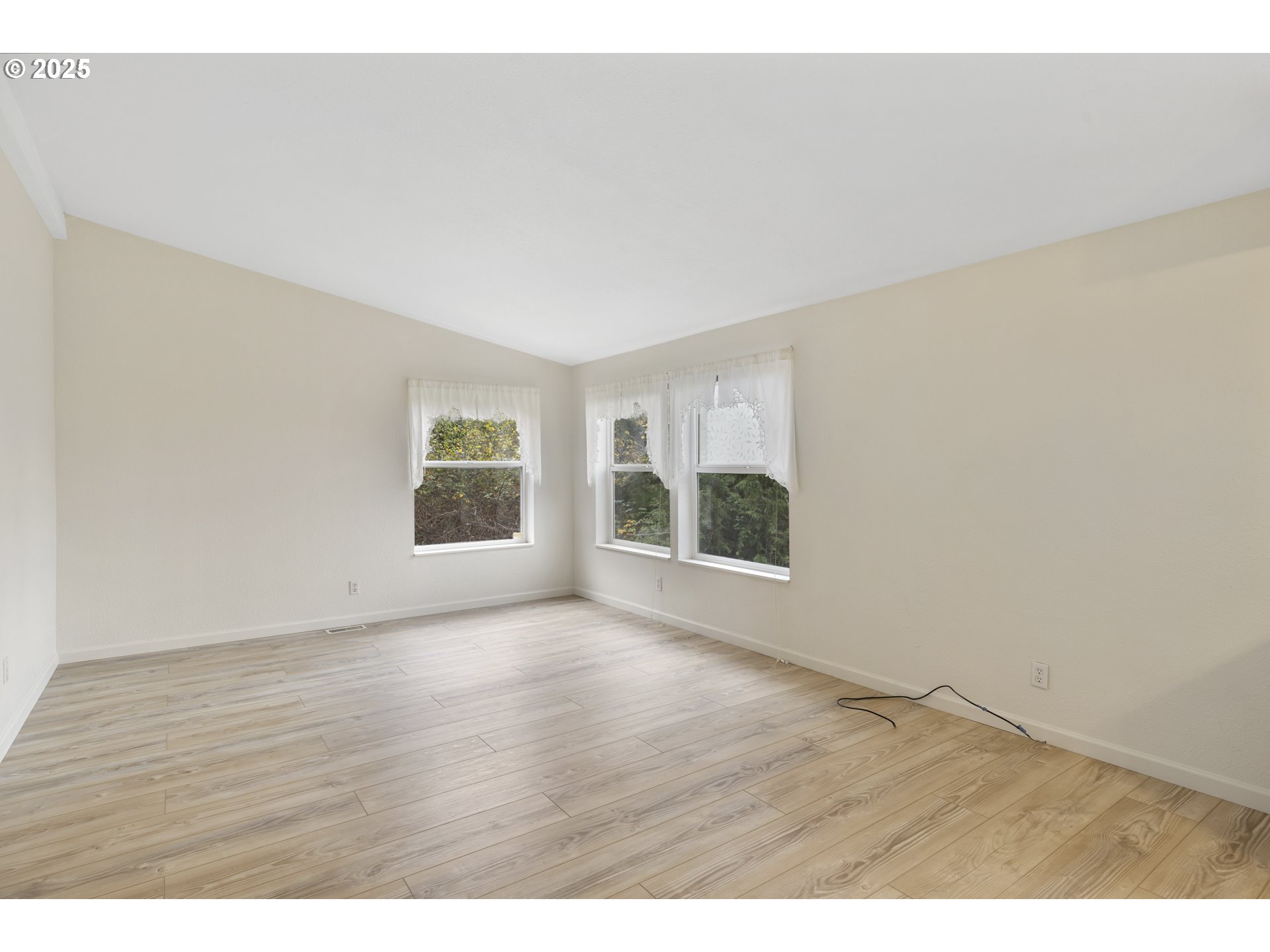 1115 China Garden Road Kalama, WA 98625 - Photo 13 of 40 a view of an empty room with wooden floor and a window