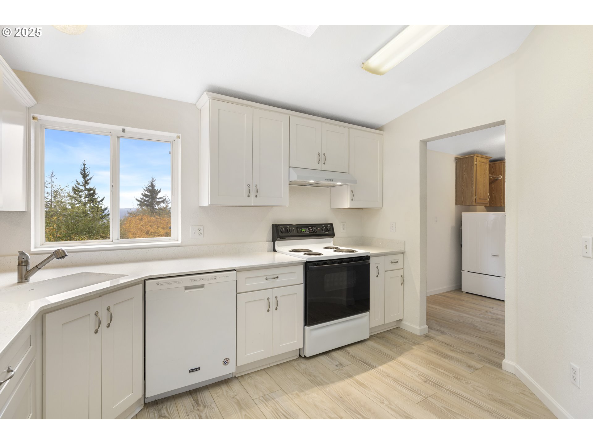 1115 China Garden Road Kalama, WA 98625 - Photo 19 of 40 a kitchen with stainless steel appliances granite countertop a stove a sink and a microwave