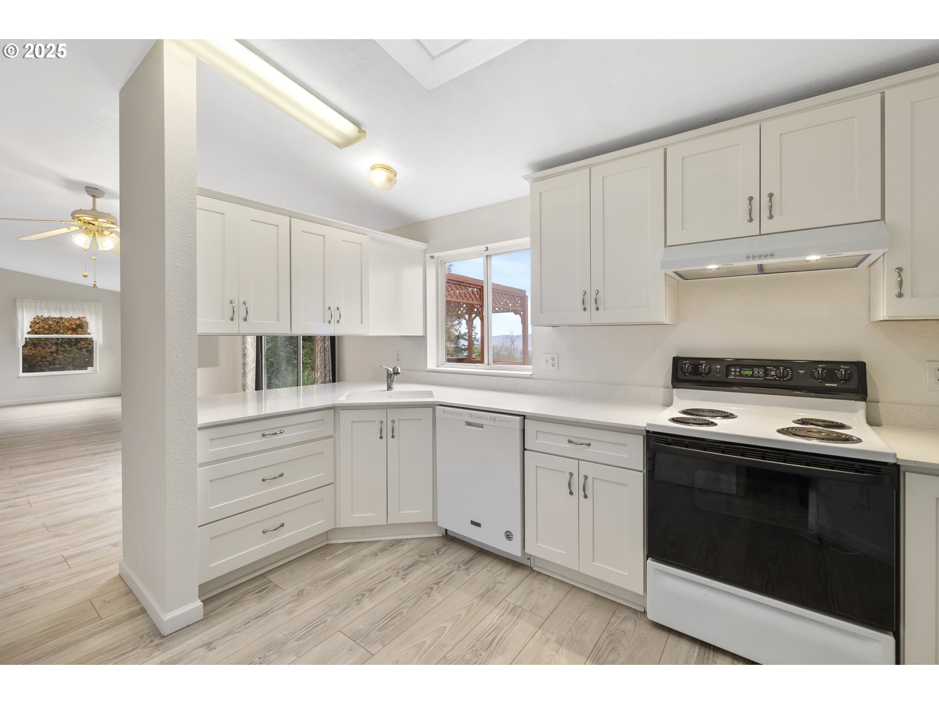 1115 China Garden Road Kalama, WA 98625 - Photo 20 of 40 a kitchen with granite countertop white cabinets and white appliances