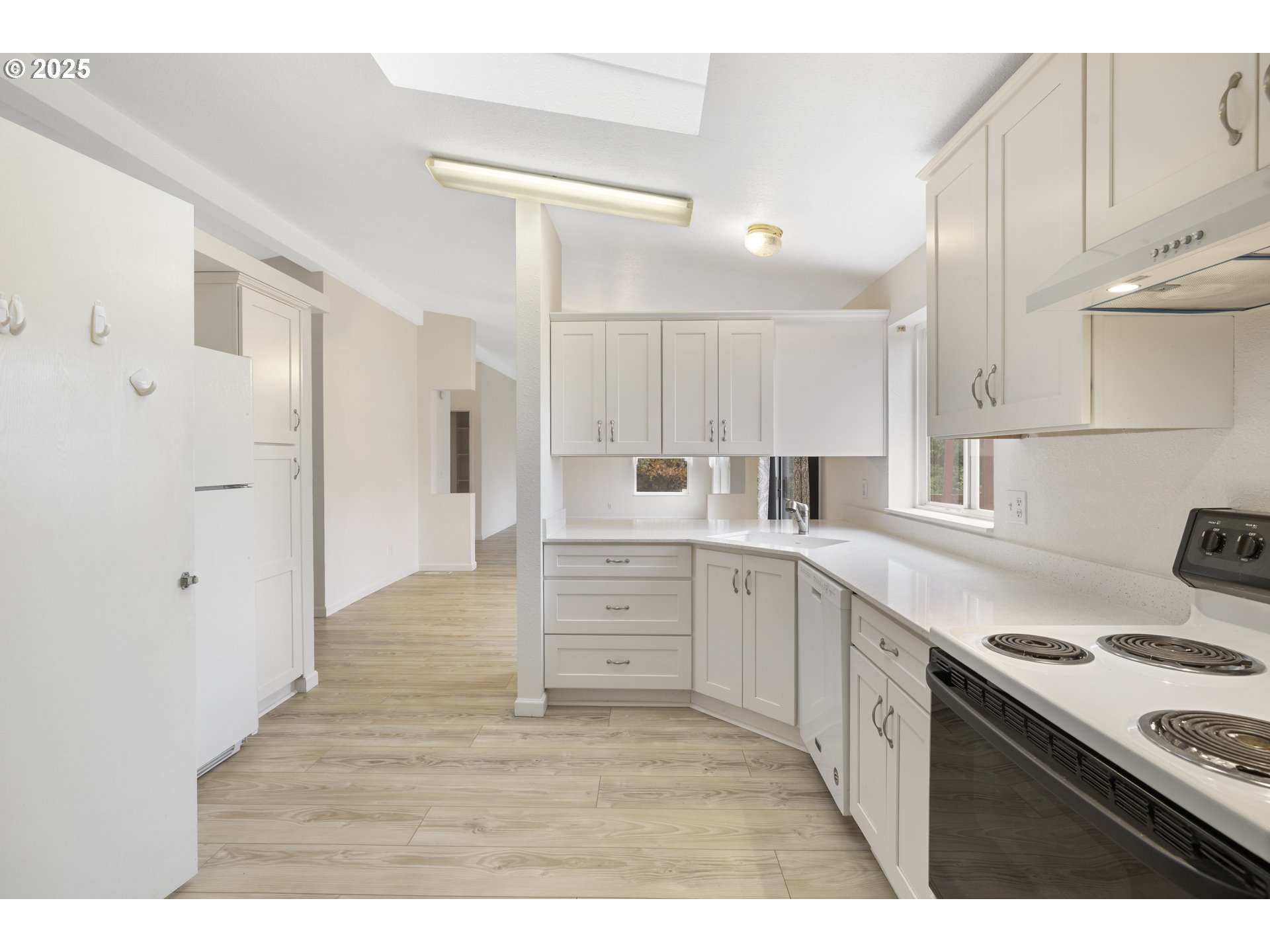 1115 China Garden Road Kalama, WA 98625 - Photo 21 of 40 a kitchen with white cabinets and white appliances