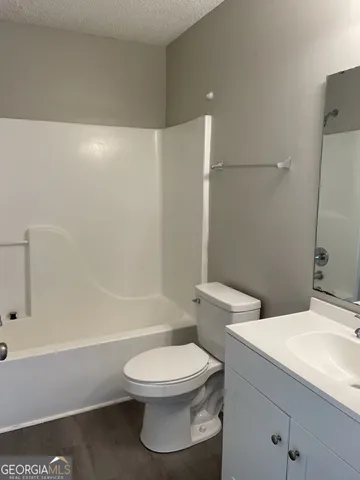 a bathroom with a toilet a sink and bathtub