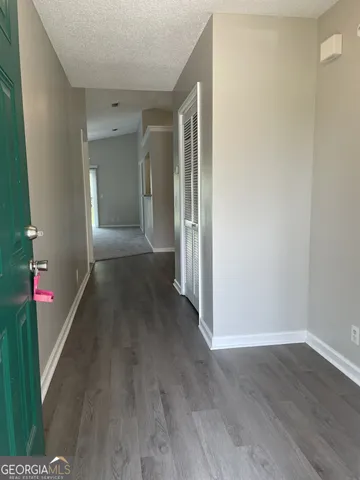 a view of a hallway with wooden floor