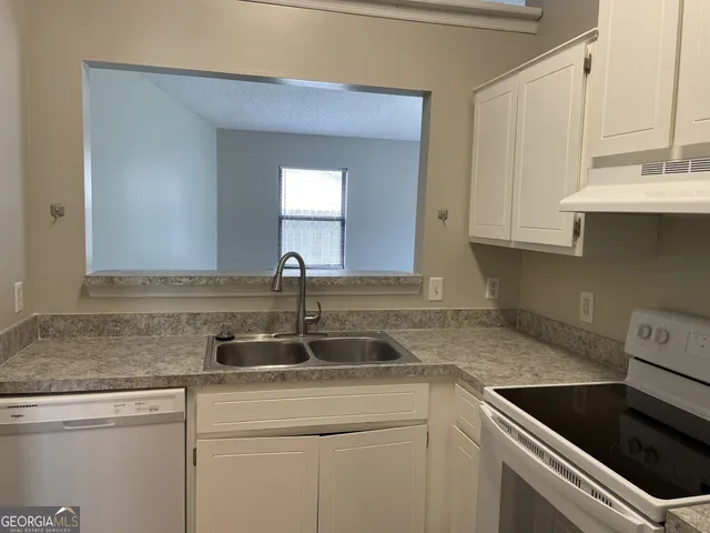 a kitchen with a sink and cabinets