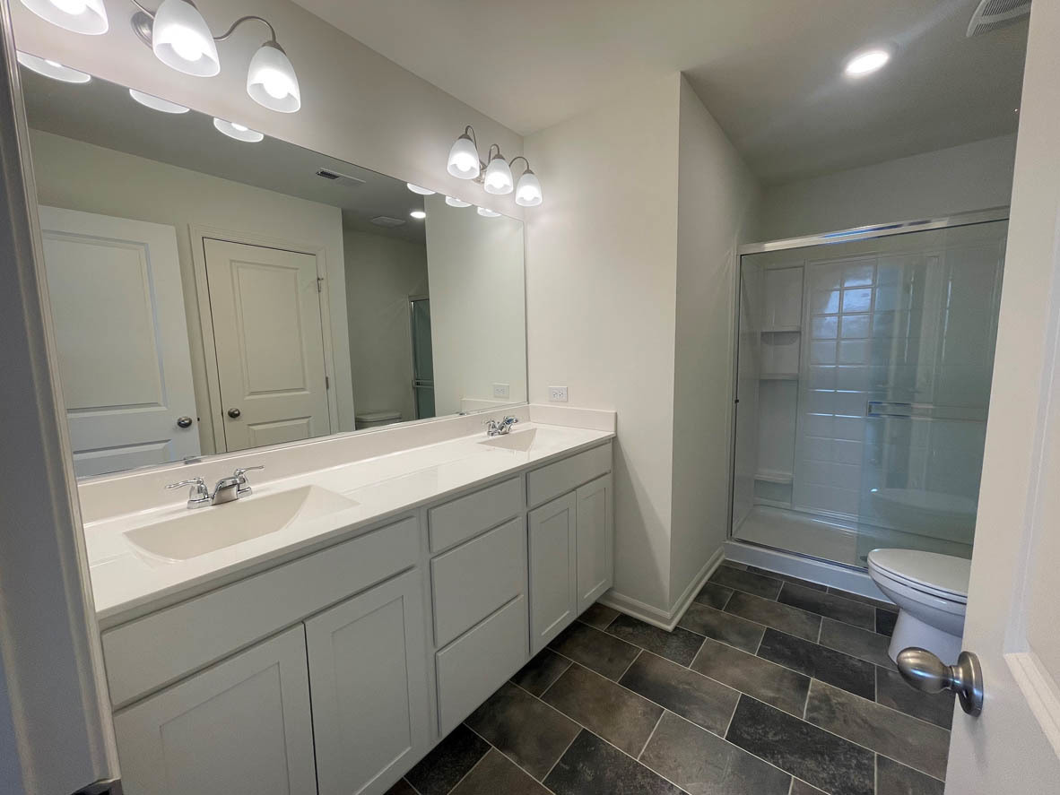 762 Westbury Drive Cary, IL 60013 - Photo 15 of 21 a bathroom with a double vanity sink mirror and shower
