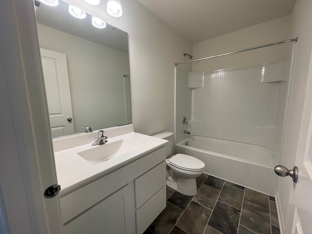 762 Westbury Drive Cary, IL 60013 - Photo 17 of 21 a bathroom with a sink a toilet a mirror and shower