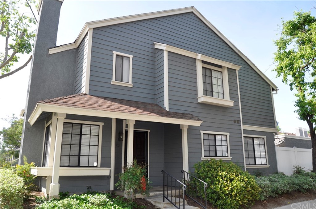 a front view of a house with plants