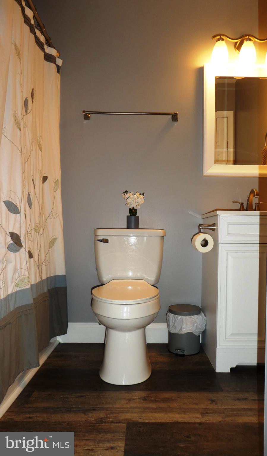 14 Springhouse Court Rising Sun, MD 21911 - Photo 5 of 13 a white toilet sitting next to a bathroom sink and vanity
