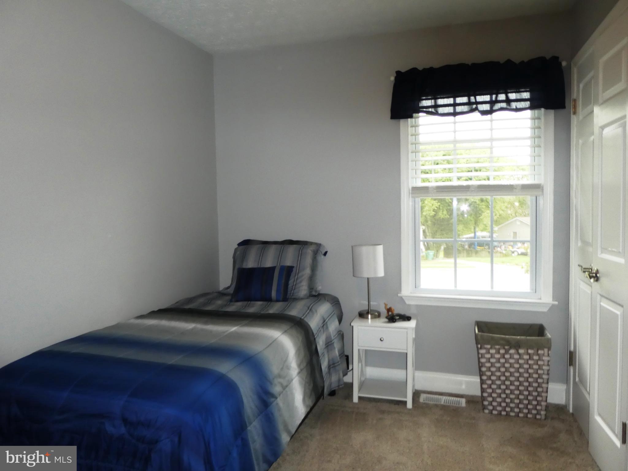 14 Springhouse Court Rising Sun, MD 21911 - Photo 7 of 13 a bed sitting in a bedroom next to a window