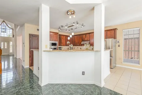 a view of kitchen with furniture and refrigerator
