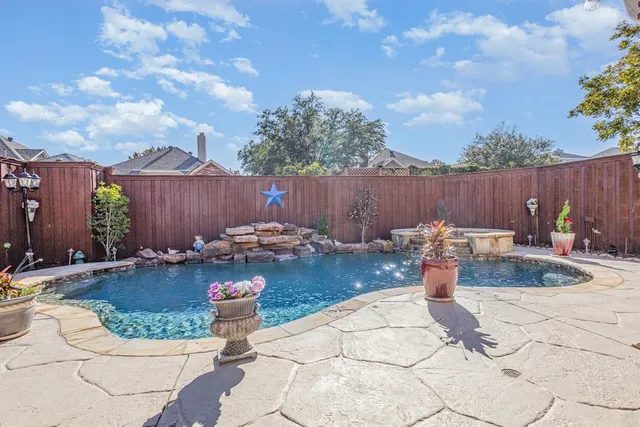 a view of a backyard with swimming pool
