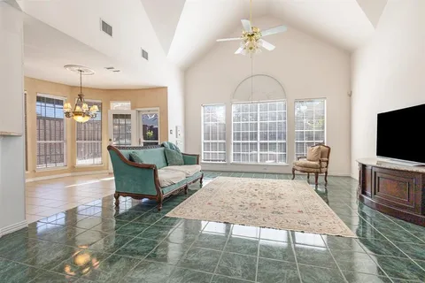 a living room with furniture a rug and a flat screen tv