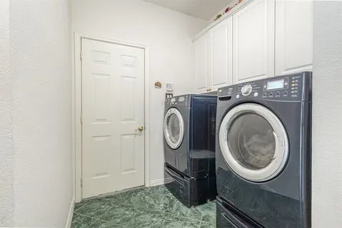 a view of storage and utility room with washer and dryer
