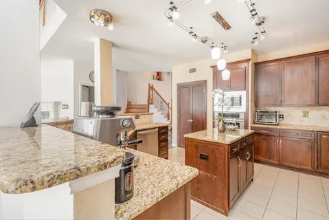 a kitchen with stainless steel appliances granite countertop a sink counter space and cabinets