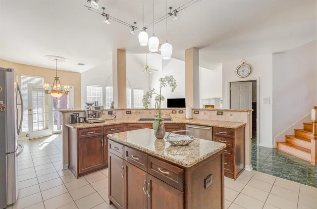 a kitchen with stainless steel appliances granite countertop a sink counter space and cabinets