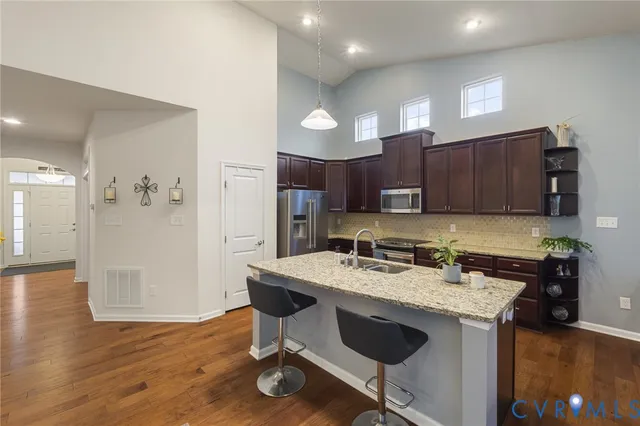 a kitchen with a table chairs refrigerator and microwave
